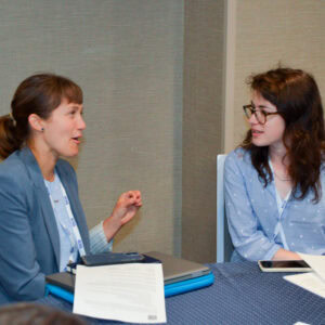 Mentor and mentee in discussion at a table