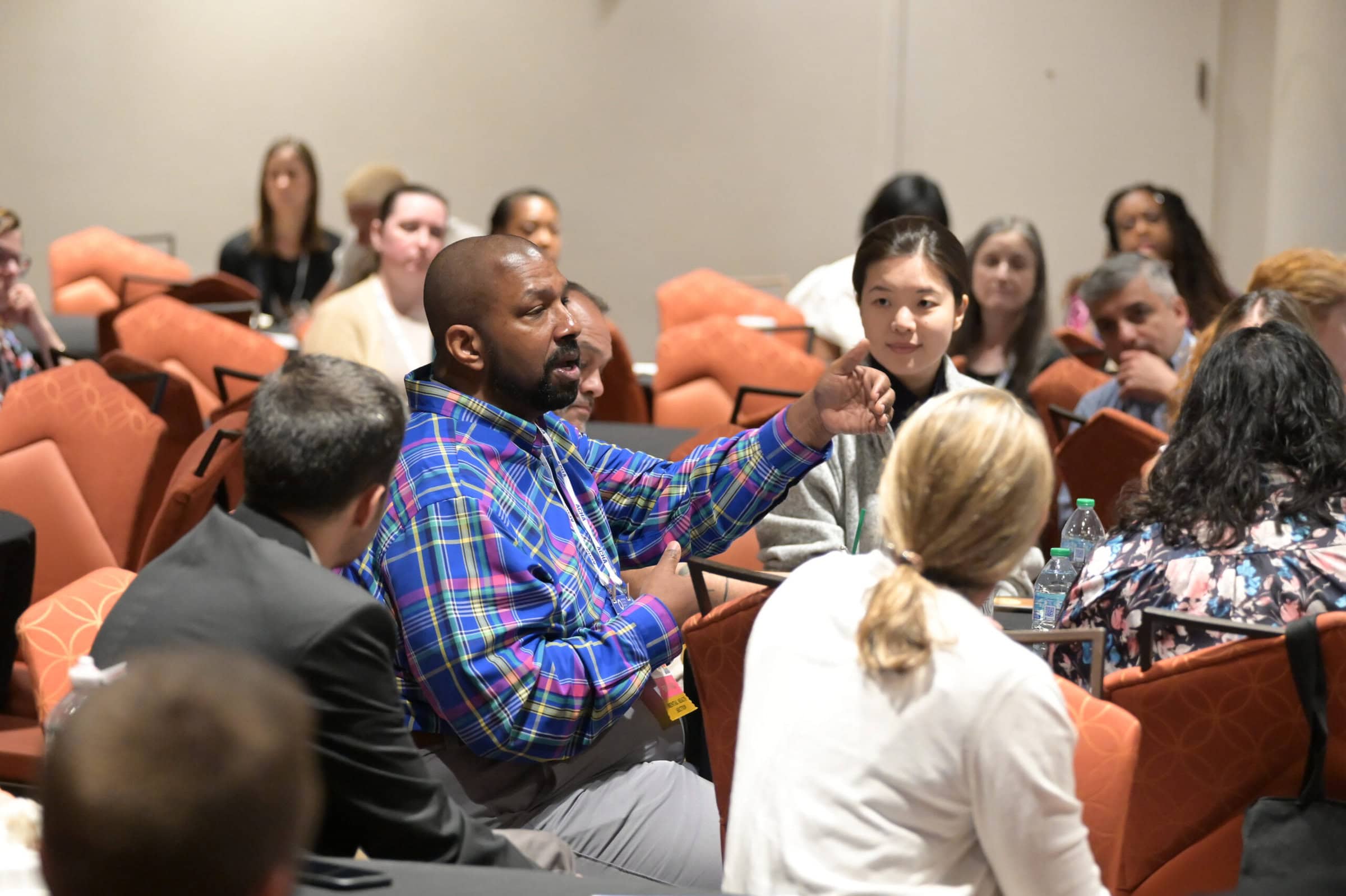 A group of individuals at the ACHA 2024 Annual Meeting having a discussion