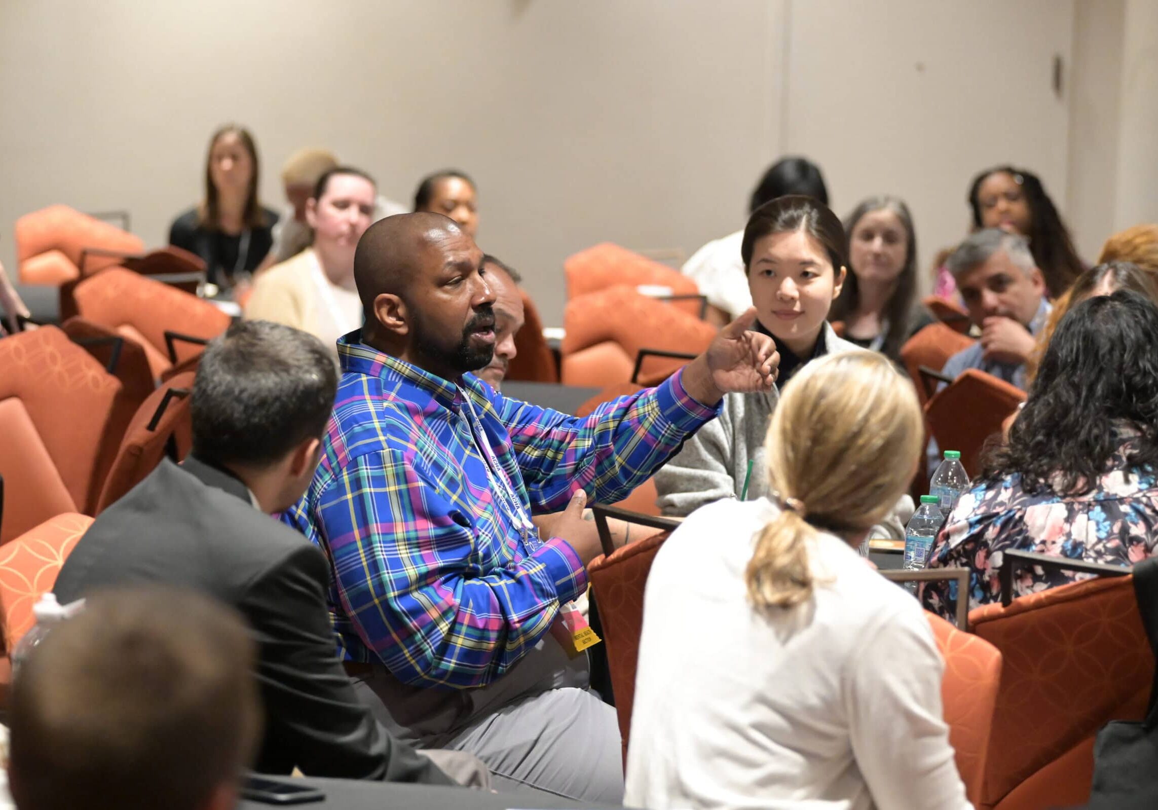A group of individuals at the ACHA 2024 Annual Meeting having a discussion